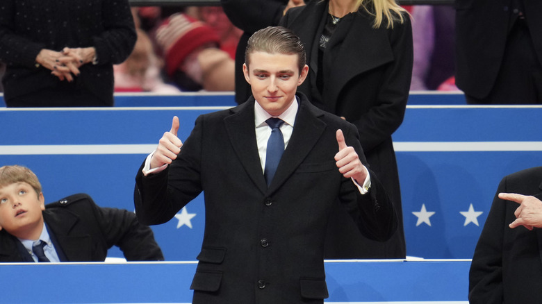 Barron Trump giving thumbs up on stage
