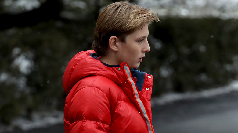 Side profile of Barron Trump walking outside
