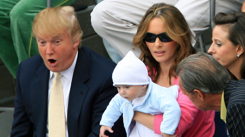 Melania and Donald Trump with an infant Barron Trump in audience