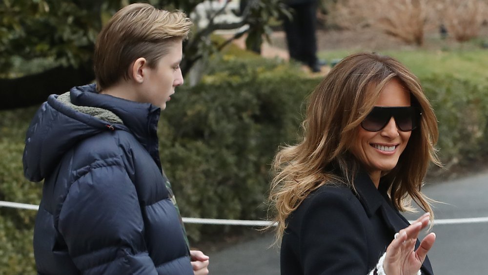 Barron and Melania Trump walking outside