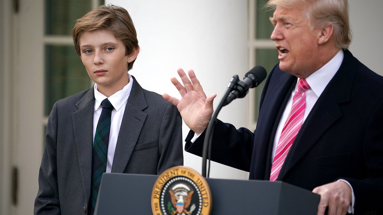 Barron Trump standing next to his father as Donald gives speech at the White House