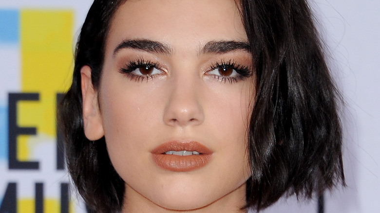 Dua Lipa looking serious with chin length hair