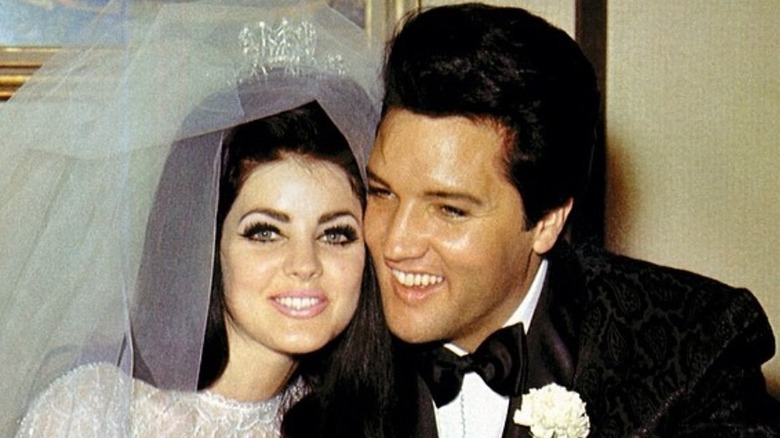 Elvis Presley smiling beside Priscilla at wedding
