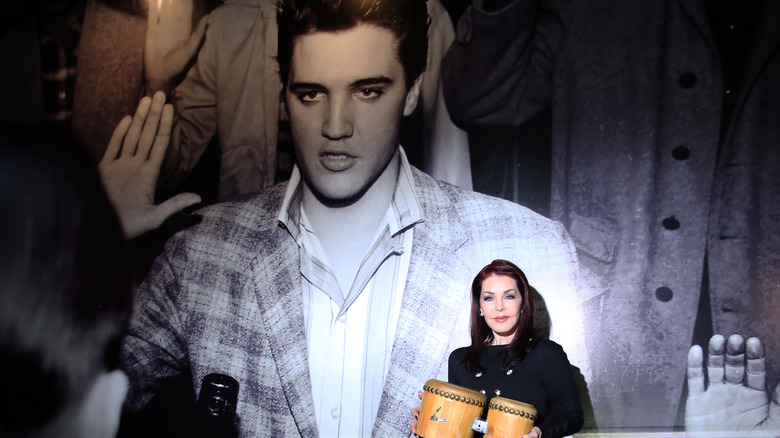 Priscilla Presley with Elvis Presley portrait