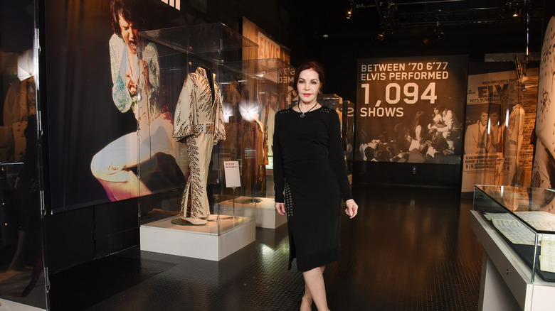 Priscilla Presley with Elvis' white jumpsuit on display