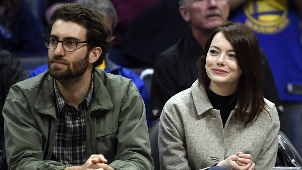 Dave McCary and Emma Stone at a basketball game