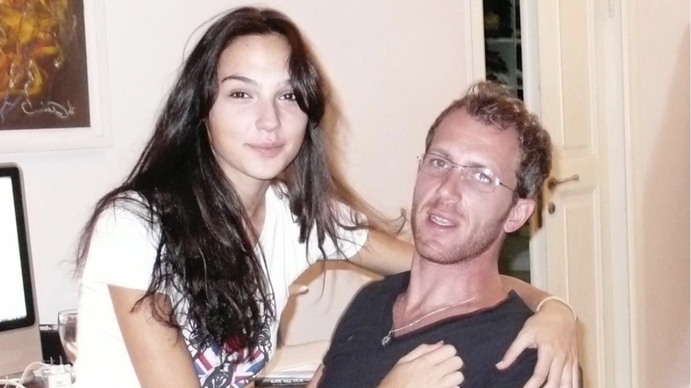 Gal Gadot sitting with Jaron Varsano at home