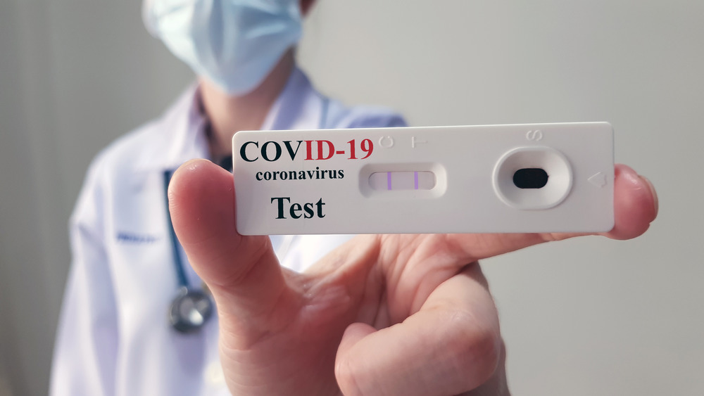 Doctor holding up COVID-19 test