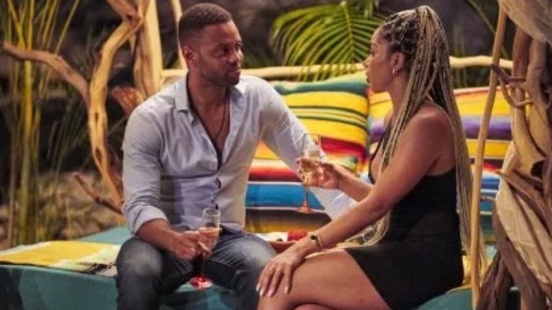 Karl Smith sits with Deandra Kanu on the beach