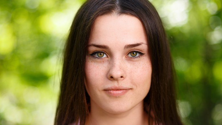 woman with dark hair and green eyes