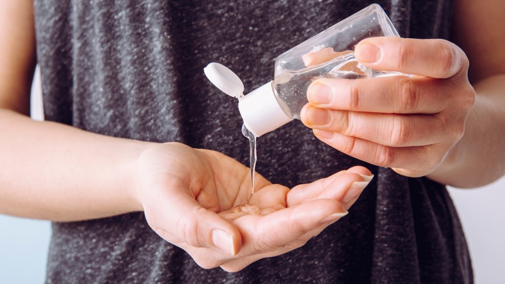 woman using hand sanitizer 