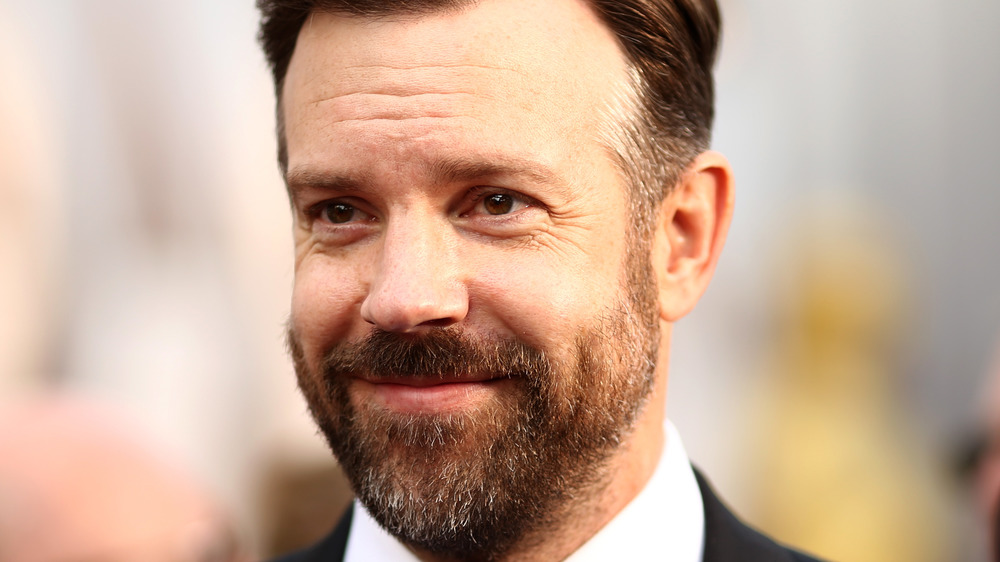 Jason Sudeikis smiling on red carpet