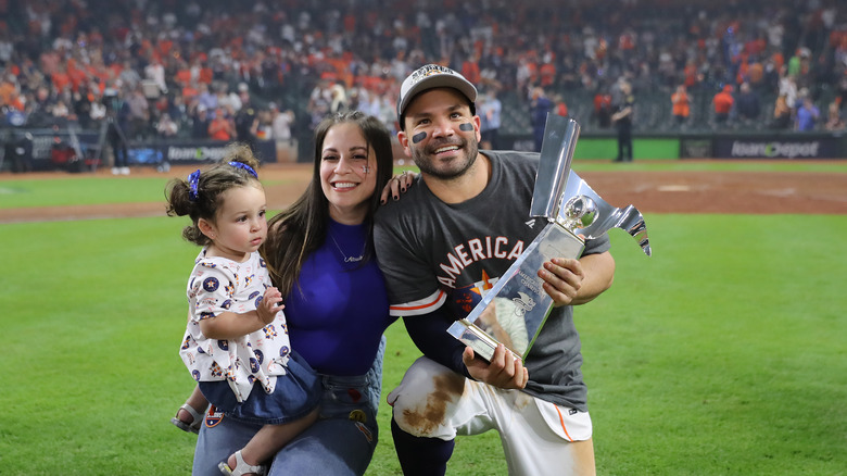 Jose Altuve, Nina Altuve and their daughter smiling 