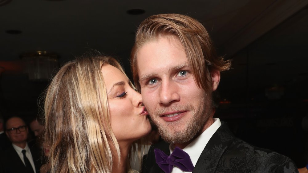 Kaley Cuoco kissing her husband, Karl Cook, on the cheek