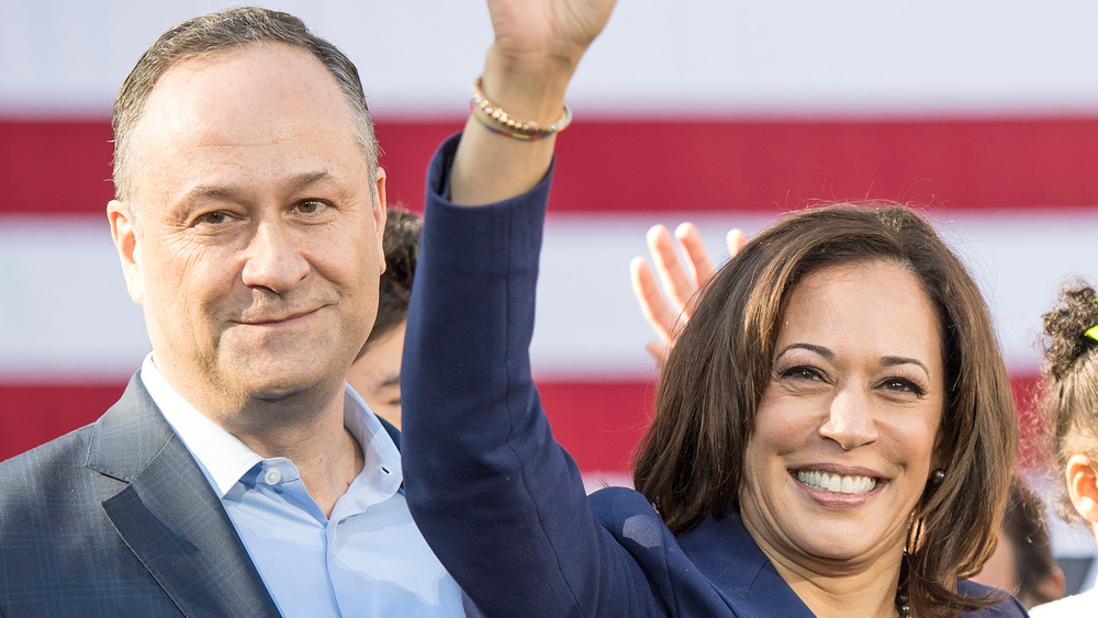 Kamala Harris and Doug Emhoff in front of a flag