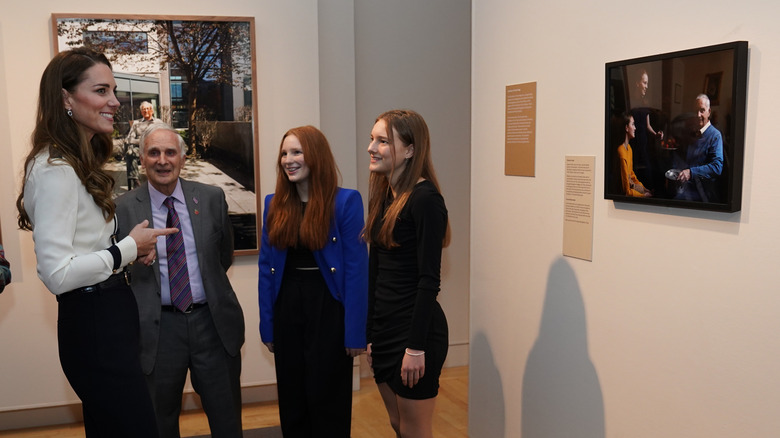 Kate Middleton speaking with people at museum
