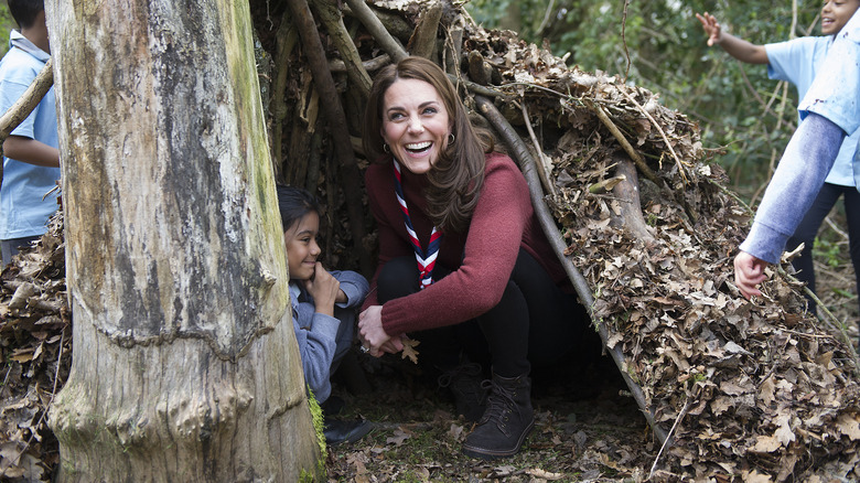 Kate Middleton in a tree fort laughing