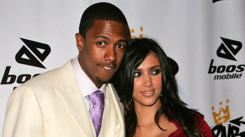 Nick Cannon and Kim Kardashian posing