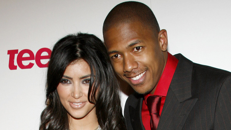 Kim Kardashian and Nick Cannon posing