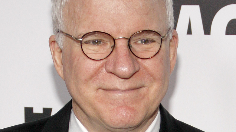 Steve Martin looking sage in glasses and a tuxedo