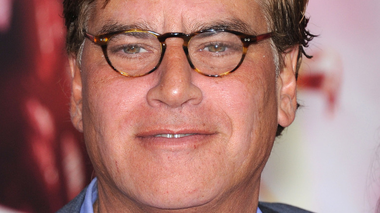 Aaron Sorkin wears glasses in close up photo