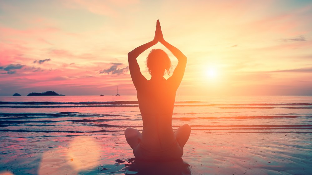 Dawn yoga meditation on a beach