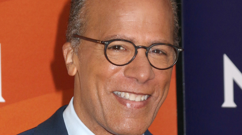 Lester Holt smiling in glasses