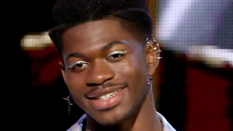Lil Nas X smiling on stage