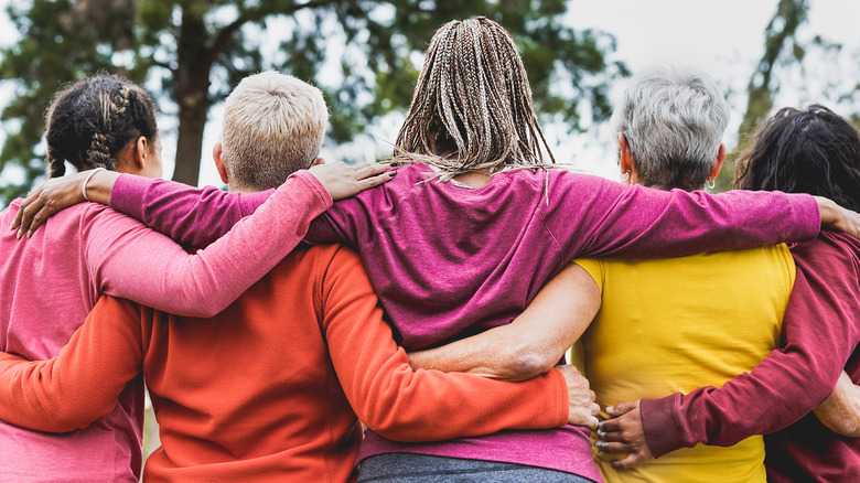 Women arms around each other