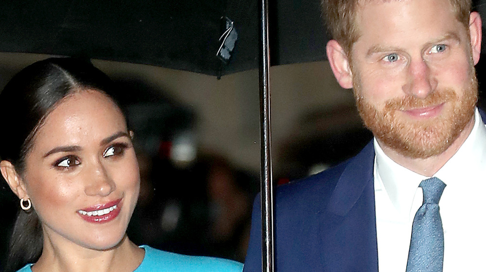 Meghan Markle and Prince Harry under umbrella