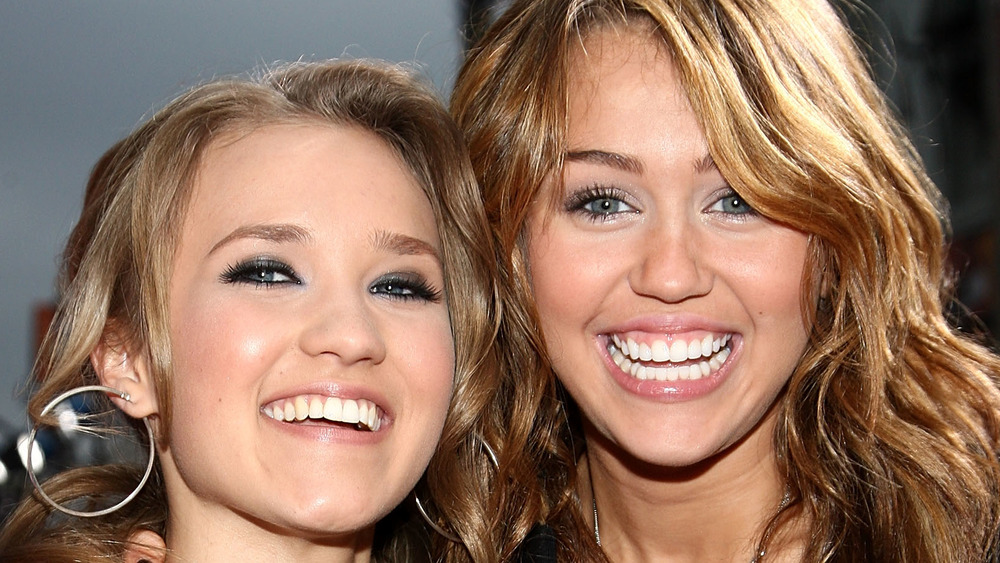 Emily Osment and Miley Cyrus pose