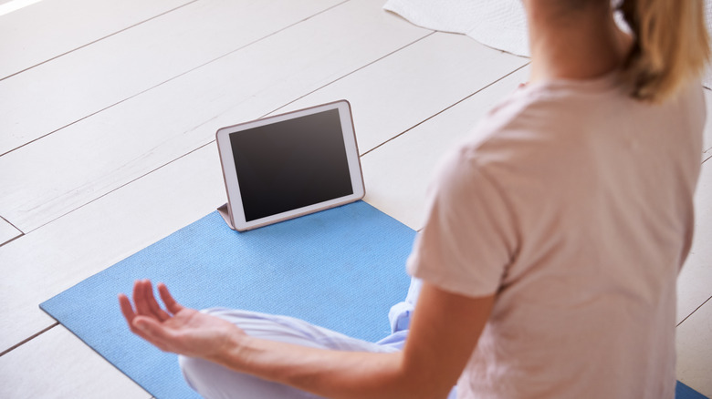woman meditating with an app