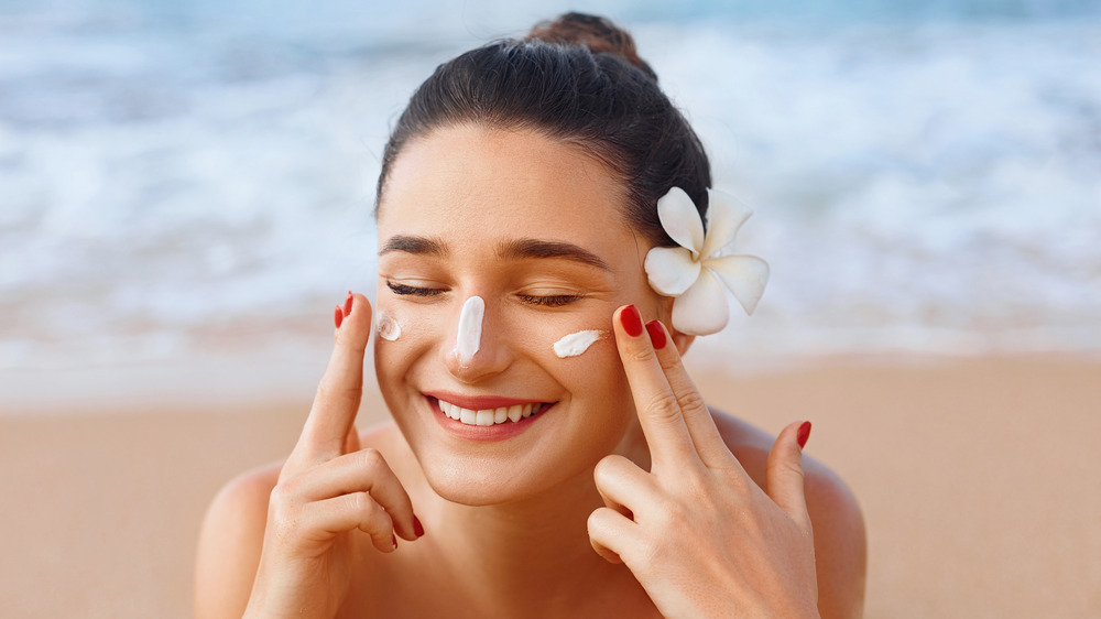 Woman applying sunscreen