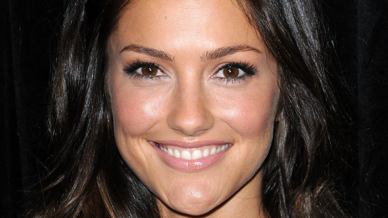 Minka Kelly smiling at the camera during an event