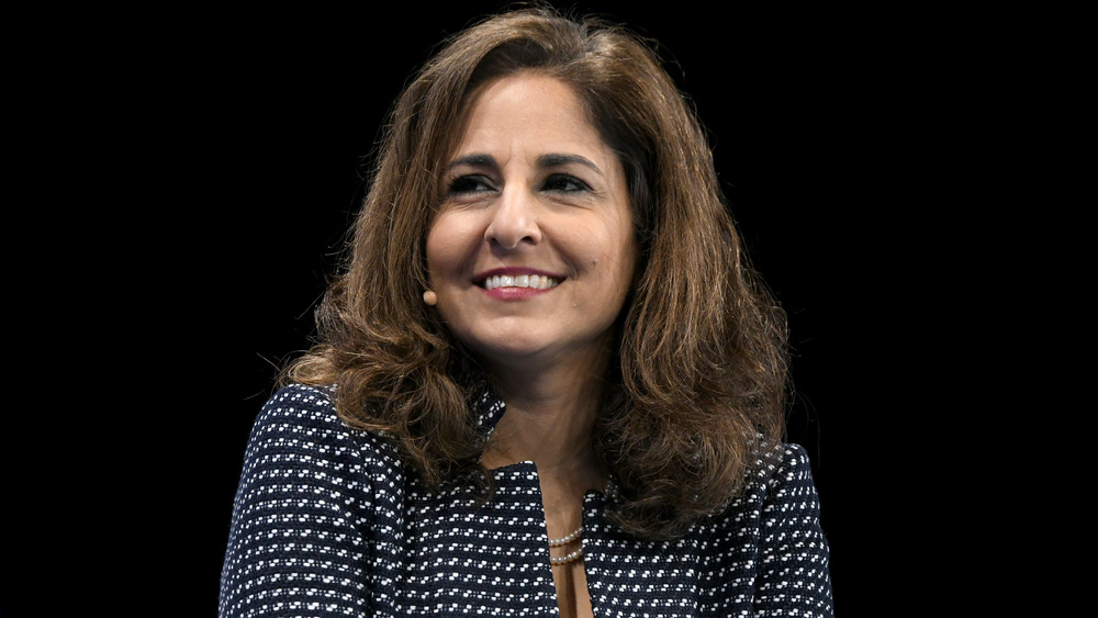 Neera Tanden looking off to the side and smiling