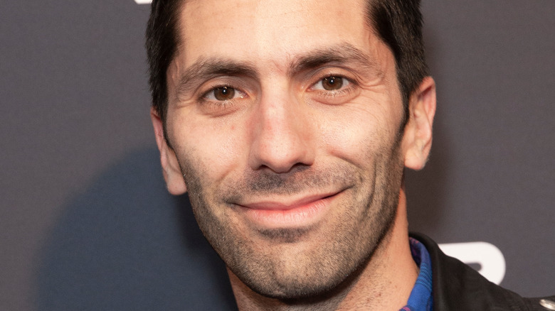 Nev Schulman smiles on the red carpet