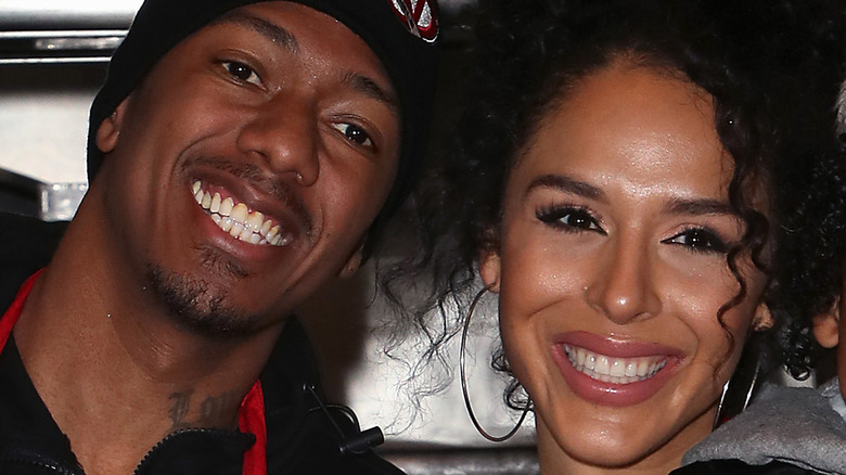 Nick Cannon and Brittany Bell at an event, with child