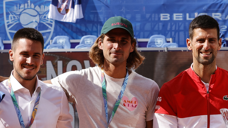 Novak, Marko and Djordje Djokovic on the tennis court