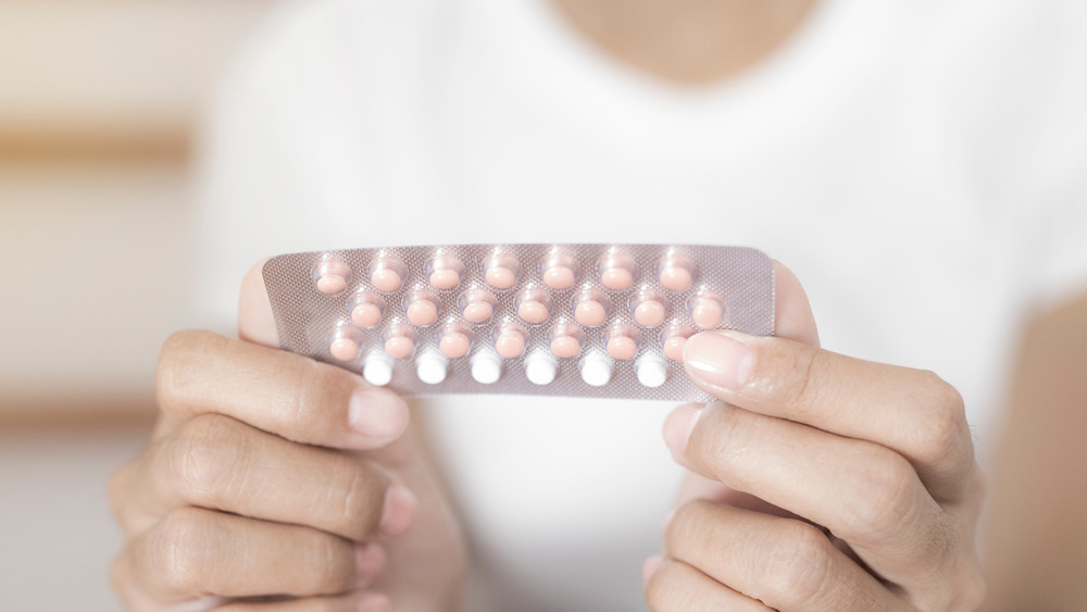 Person holding birth control pack