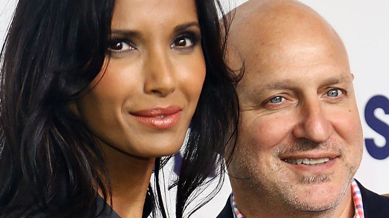 Padma Lakshmi and Tom Colicchio smile together.