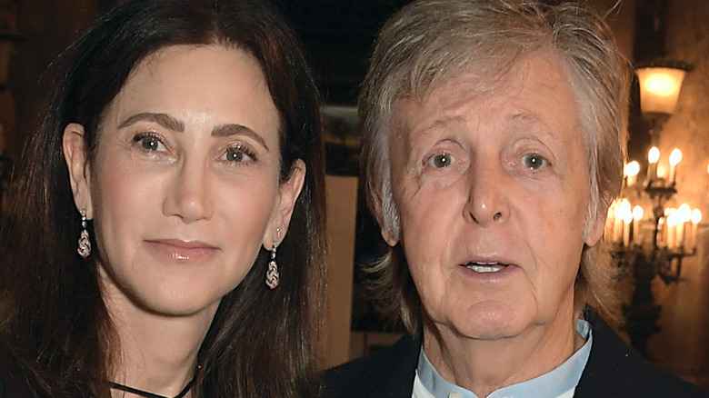 Paul McCartney and Nancy Shevell posing at event