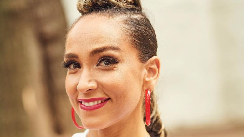 Robin Arzon smiling in hoop earrings