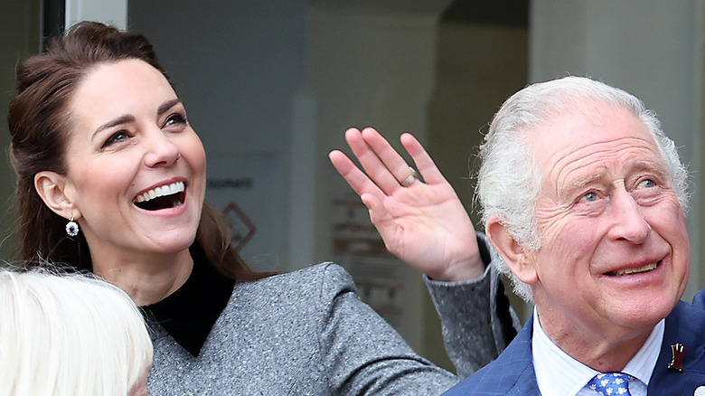 Kate Middleton and King Charles smile and wave during an outing. 