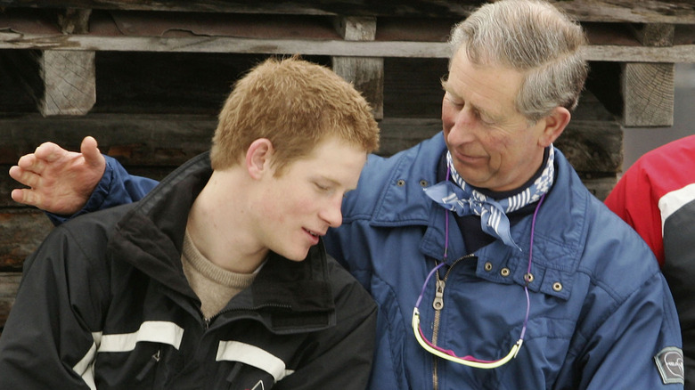 King Charles with arm around Prince Harry 