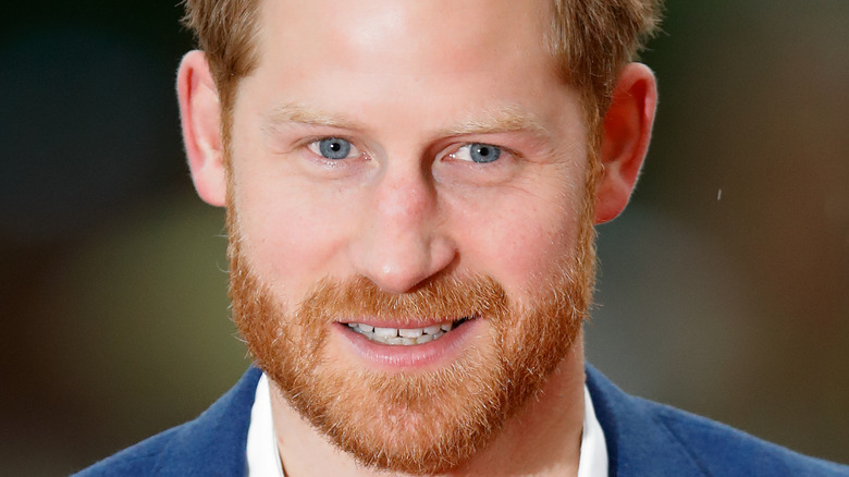 Prince Harry smiling with facial hair