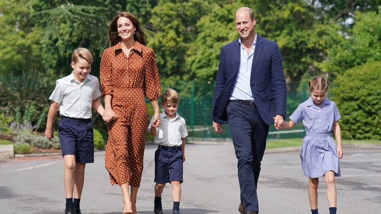 Princess Catherine and Prince William walking with their three children