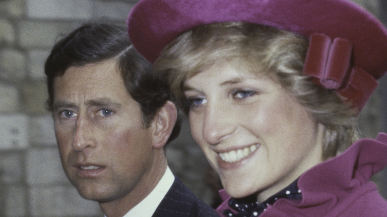 Princess Diana smiles next to Prince Charles