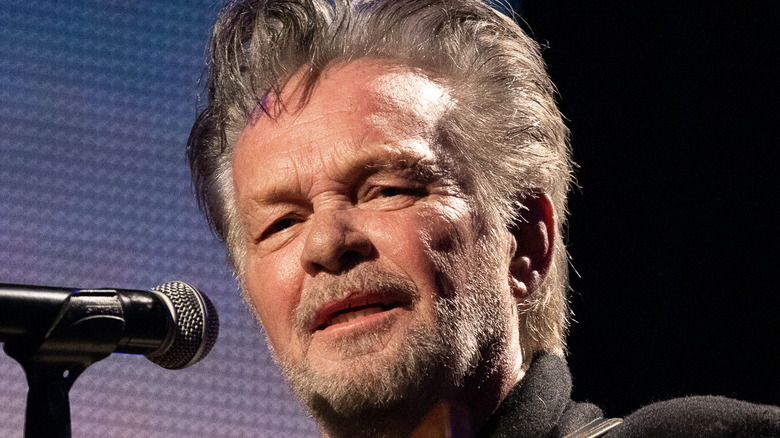 John Mellencamp performing on stage 