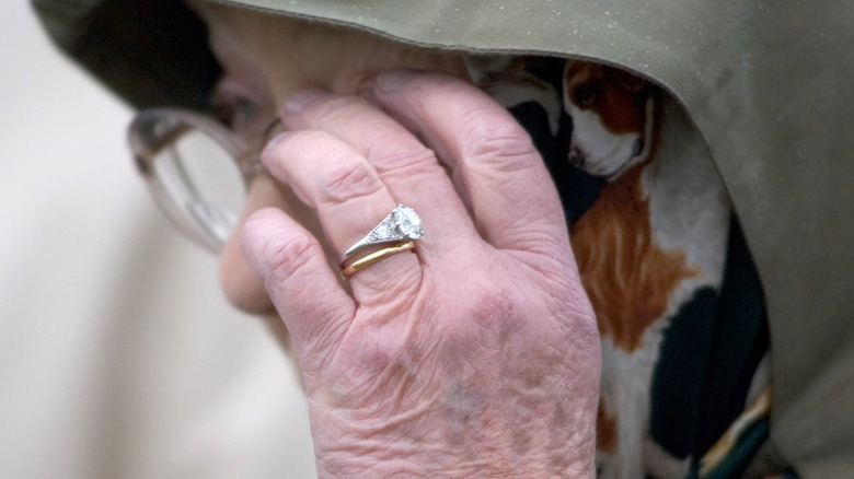 Close up of Queen Elizabeth's engagement ring and wedding band