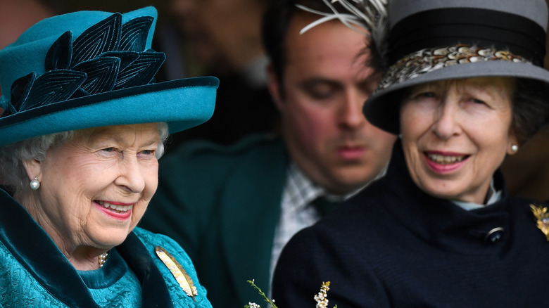 Queen Elizabeth in blue and Princess Anne attend an event together